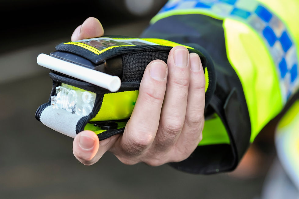 Police man holding breathalyser