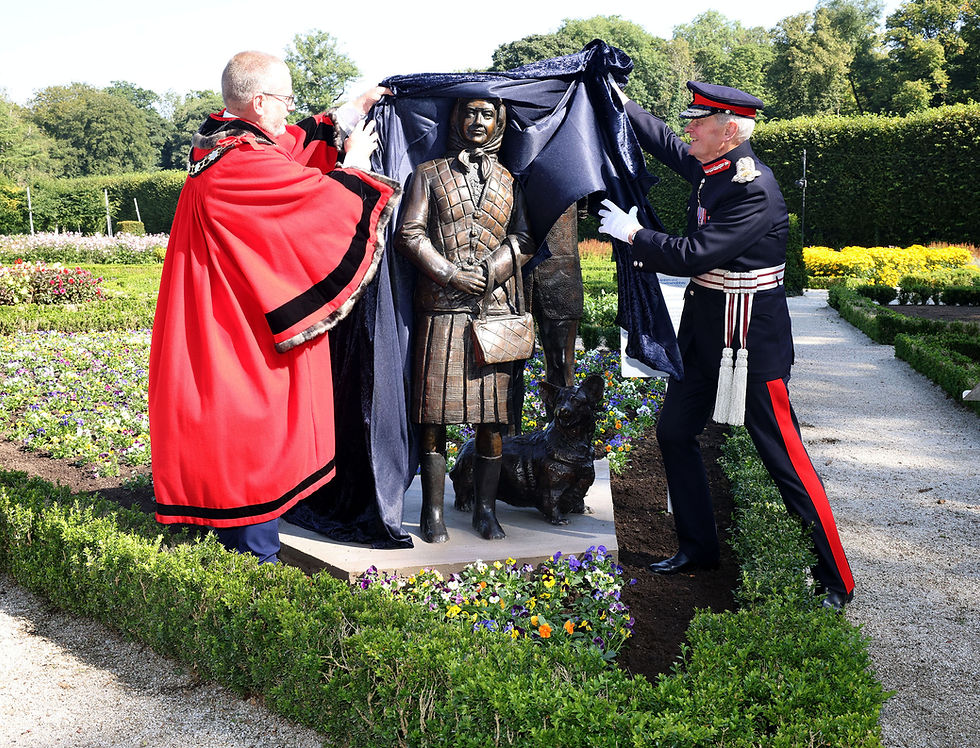 The Lord-Lieutenant of County Antrim, Mr David McCorkell KStJ and Deputy Mayor of Antrim and Newtownabbey, Councillor Paul Dunlop BEM unveil a sculptor of Her Late Majesty, Queen Elizabeth II at Antrim Castle Gardens
