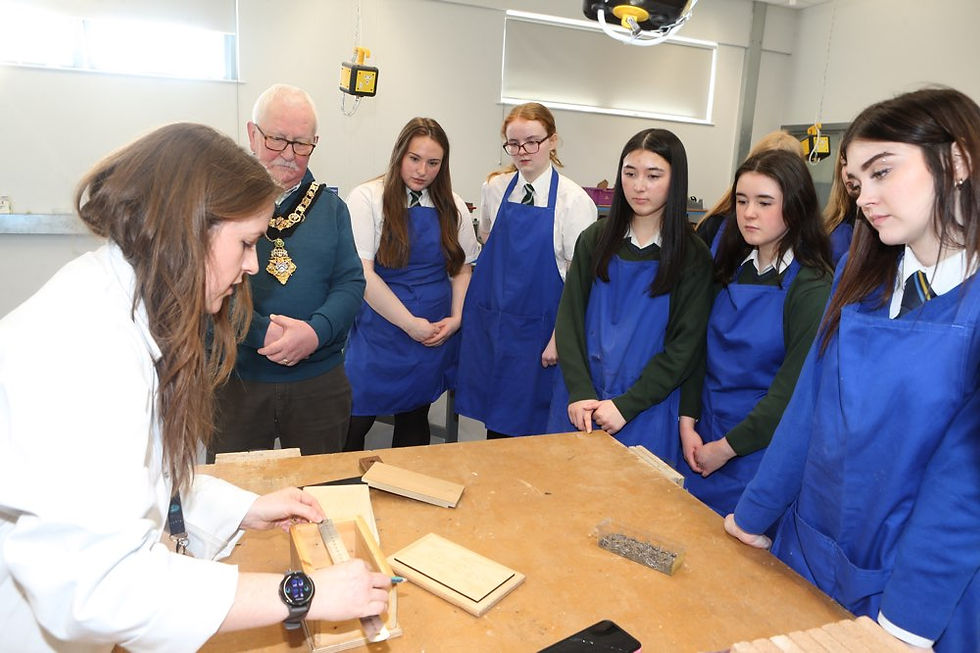The Mayor, Councillor Oliver McMullan, watches a woodwork demonstration alongside four pupils from Cross and Passion College and Ballycastle High School, together with pupils from St Mary’s High School, Limavady and Limavady High School, during the ‘Mayor for a Day’ initiative at the Limavady Shared Education Campus marking International Women’s Day.