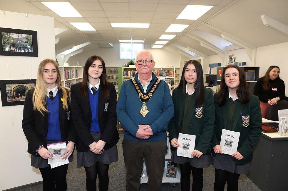 Four pupils, Demi Timperley and Aimee Dillon from Cross and Passion College and Carragh Rafferty and Jenna Brennan from Ballycastle High School, are pictured with the Mayor of Causeway Coast and Glens, Oliver McMullan, during a visit to the newly refurbished library in Ballycastle as part of the ‘Mayor for a Day’ initiative marking International Women’s Day.