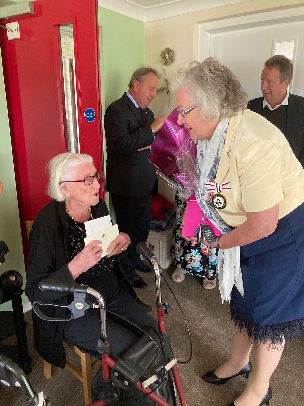 Dr Sheelagh Hillan, MBE, DL presenting a card from The King and Queen to Maisie.