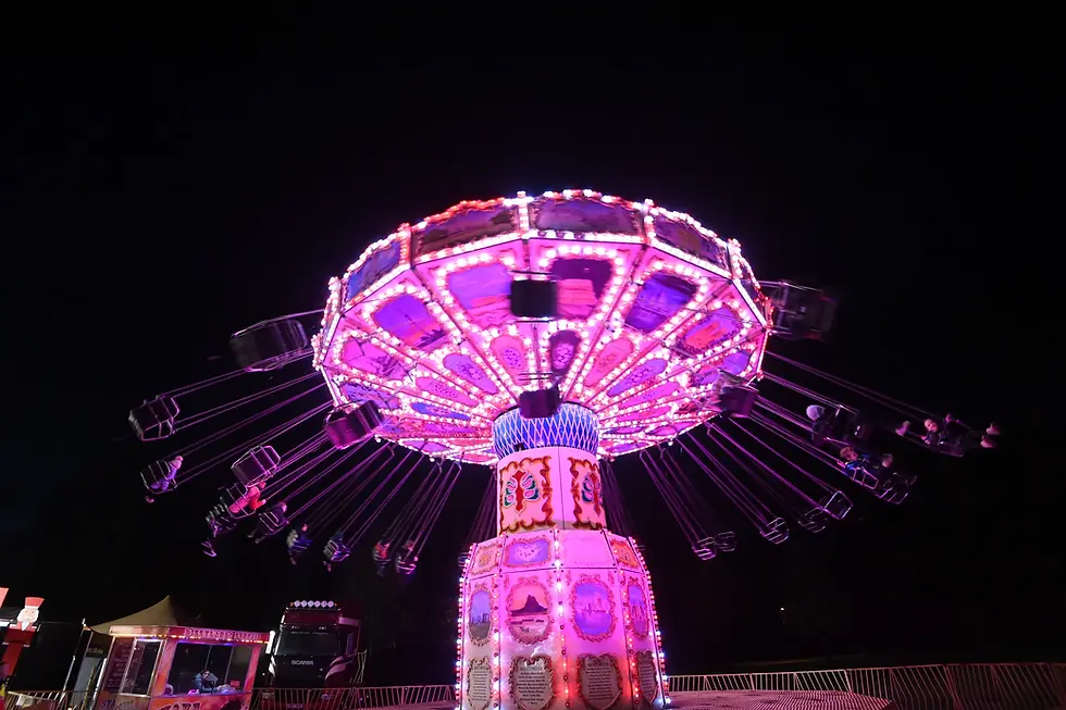 Pink swinging chairs outdoor amusement at night time