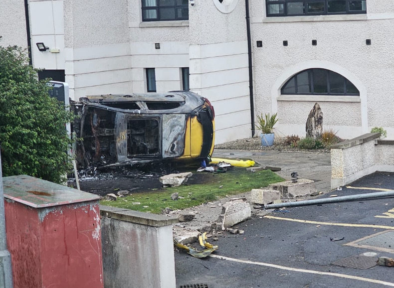 The scene at Ballycastle Golf Club where a car crashed and overturned before being destroyed by fire.