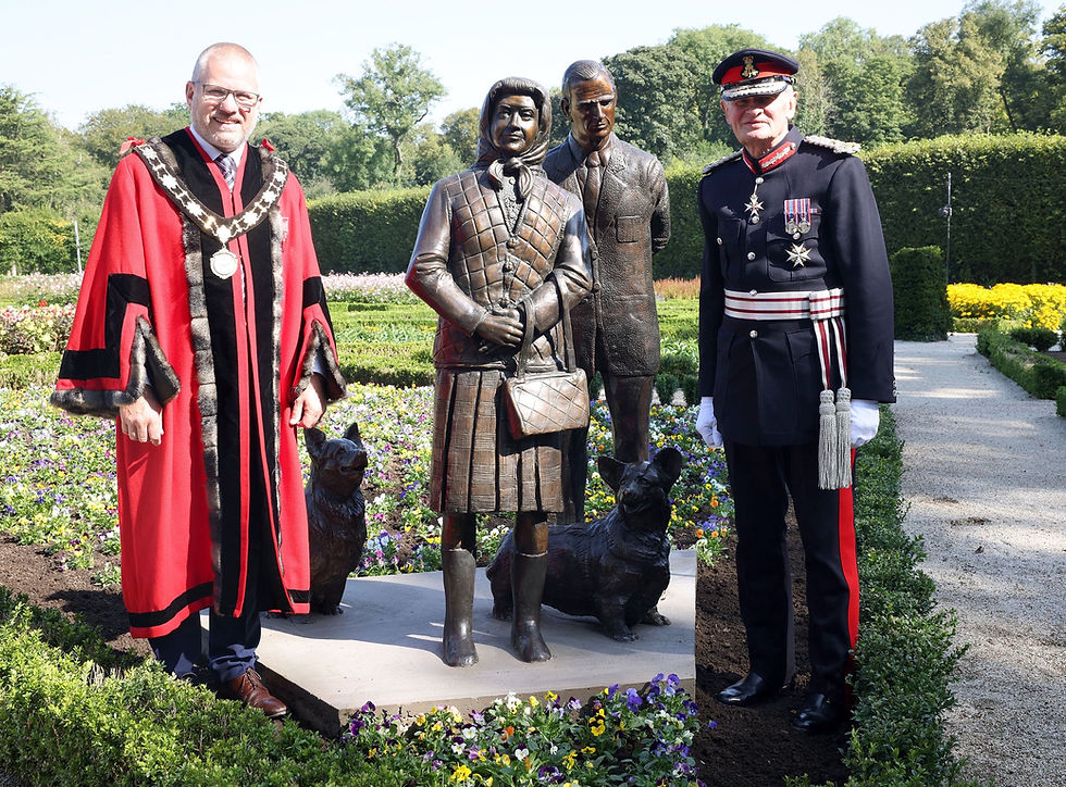 The Lord-Lieutenant of County Antrim, Mr David McCorkell KStJ and Deputy Mayor of Antrim and Newtownabbey, Councillor Paul Dunlop BEM with the sculpture of Her Late Majesty, Queen Elizabeth II at Antrim Castle Gardens