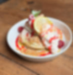 Lemon and Raspberry Cheesecake Pancakes! House-made buttermilk pancakes topped with lemon cheesecake filling, raspberry coulis, lemon curd, lemon pieces, raspberries and fresh mint.