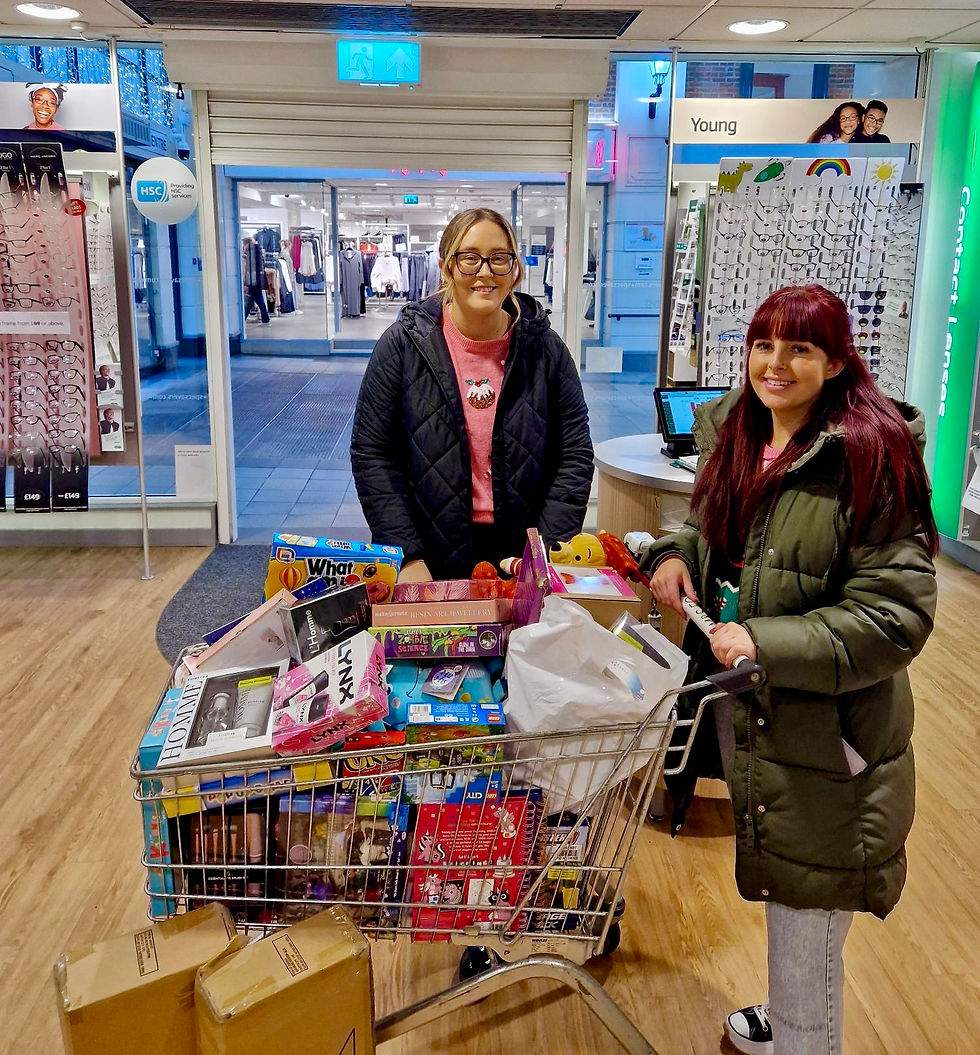 Pictured with the trolley stacked full of gifts for Cash for Kids are Optical Assistants from Specsavers Ballymena, Sophie Smyth and Lauren McCambridge