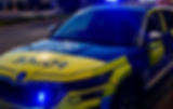 PSNI police car with blue emergency flashing lights 
