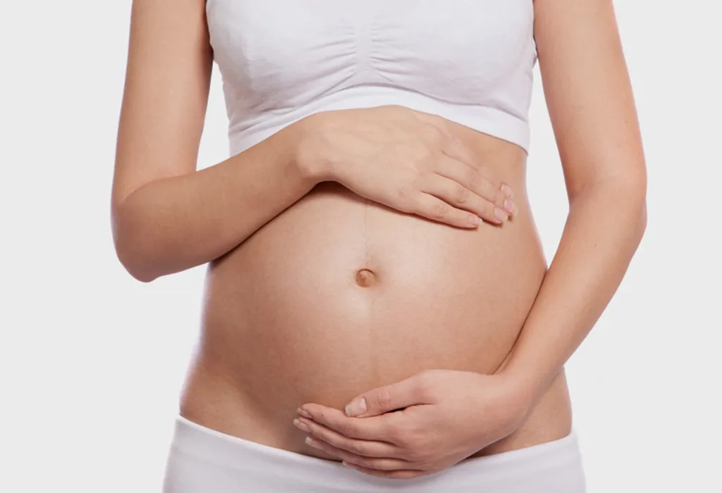 Woman holding her pregnant tummy.