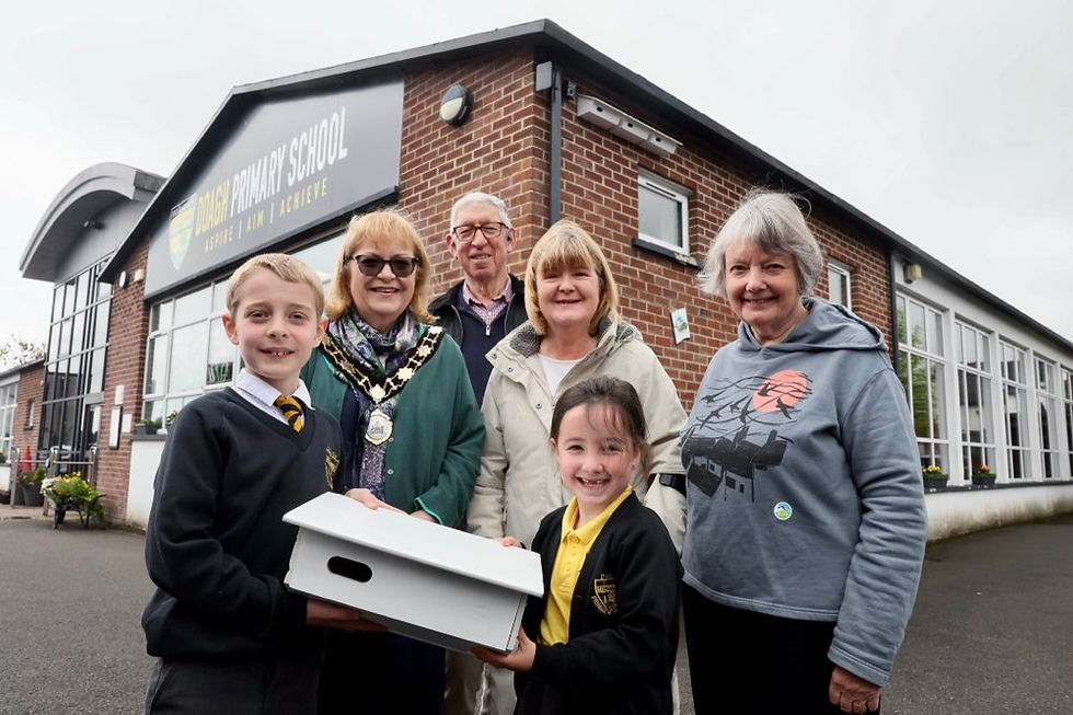 Doagh Primary School pupils celebrate the installation of three new swift nest boxes and a caller system at alongside the Outgoing Deputy Mayor Cllr Gilmour, RSPB Antrim Local Group representatives Edward McKee, Esther McKee and Kate McAllister. 