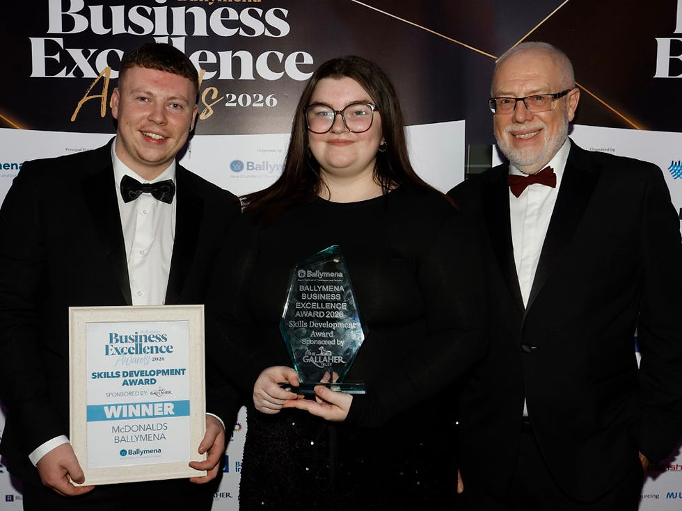 Jake Irvine and Beth Williams of McDonalds Ballymena receive the Skills Development Award from Roy Douglas of the Gallaher Trust.