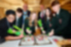 Pupils form Cambridge House Grammar School try their hand at cupcake decorating under the guidance of chef, Sandra McCooke as the Mayor of Mid and East Antrim Borough Council, Councillor Jackson Minford and Colin Johnston, CEO of Galgorm Collection look on.