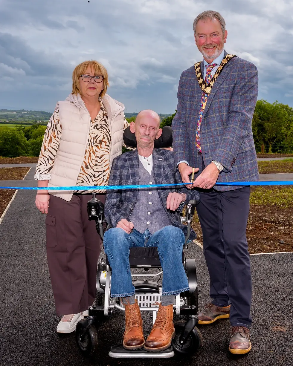 Ian and Tracy Hazlett pictured with the former mayor of Mid and East Antrim, Alderman William  McCaughey, in May, at the opening of the newly extended and upgraded cemetery in Clough.