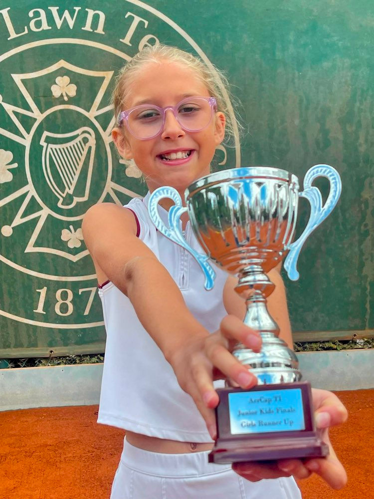 Ten-year-old Ballymena tennis player Emma Maria Mezei proudly presents her runner up trophy after reaching the final of William Fry All Ireland U10 Junior Championships