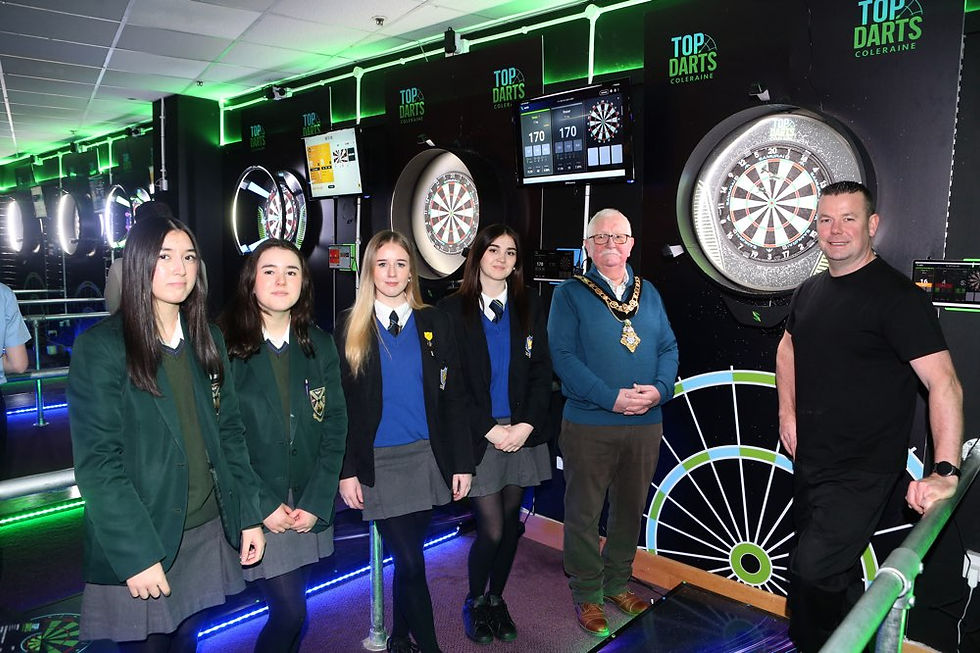 Demi Timperley and Aimee Dillon from Cross and Passion College and Carragh Rafferty and Jenna Brennan from Ballycastle High School are pictured with the Mayor, Oliver McMullan, and the owner of Top Darts in Coleraine during the ‘Mayor for a Day’ initiative marking International Women’s Day.