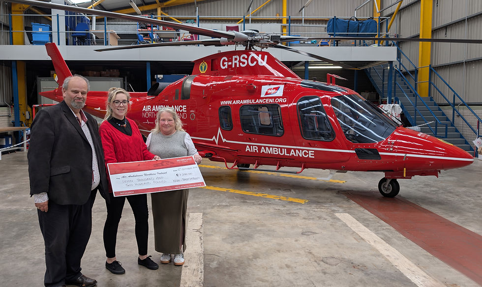 Kevin and Tracey McAuley present a cheque for £7200 to Katrina Hughes from AANI