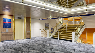 Ship lobby with wayfinding deck plans and direction signs