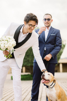 groom petting his dog