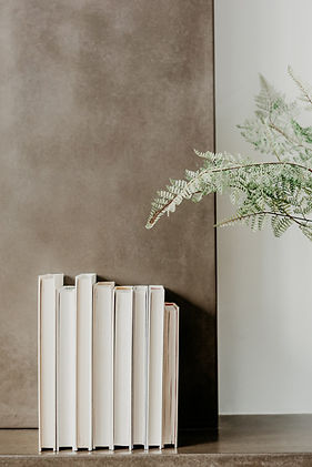 a stack of books and a plant
