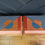 Thumbnail: Pair of Stag Minstrel Leggy Bedside Tables with Hand-Painted Geometric design