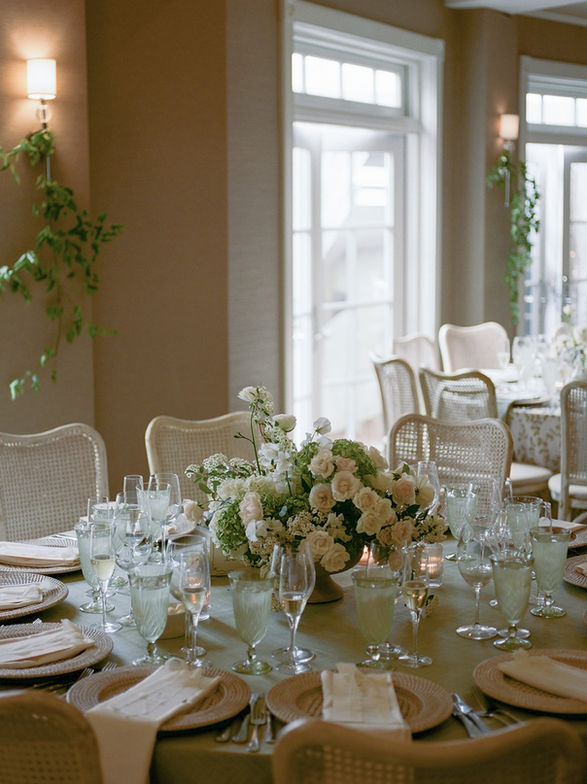green and white centerpiece on round table for a summer wedding on Lake Michigan