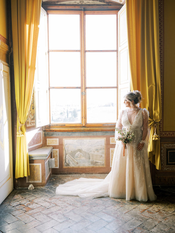 villa corsini bride photo near window draped with velvet curtains