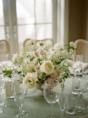 centerpiece for round table with ranunculus spirea and roses white and green