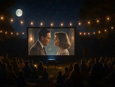 “Families and friends enjoying a magical outdoor movie night under a starry sky, gathered on blankets and lawn chairs around a glowing movie screen, with warm string lights and a full moon creating a cozy, cinematic atmosphere.”