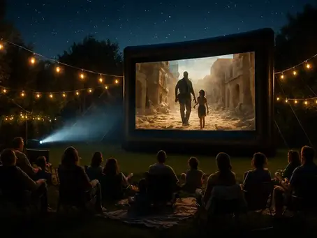 "Families enjoying an outdoor movie night in a backyard under a starry sky, seated on lawn chairs and blankets facing a large inflatable screen showing a cinematic scene, with warm string lights creating a cozy atmosphere."