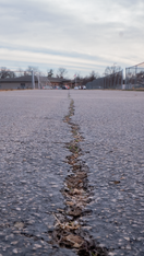 Close-up shot of cracked asphalt. 