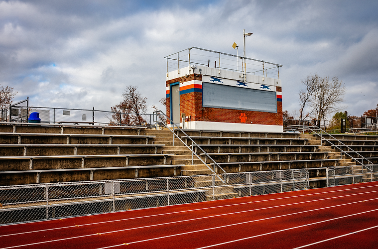 Old and weathered bleachers and press box at Clayton High School.