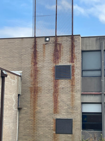 Rust and water damage visible on an exterior wall at Fairfield Middle School