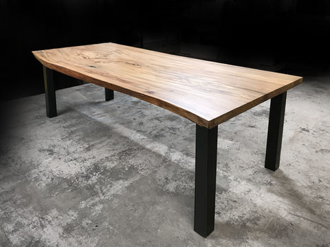 Live edge dining table shown with parson style legs with a live edge walnut wood tree slice slab table top.