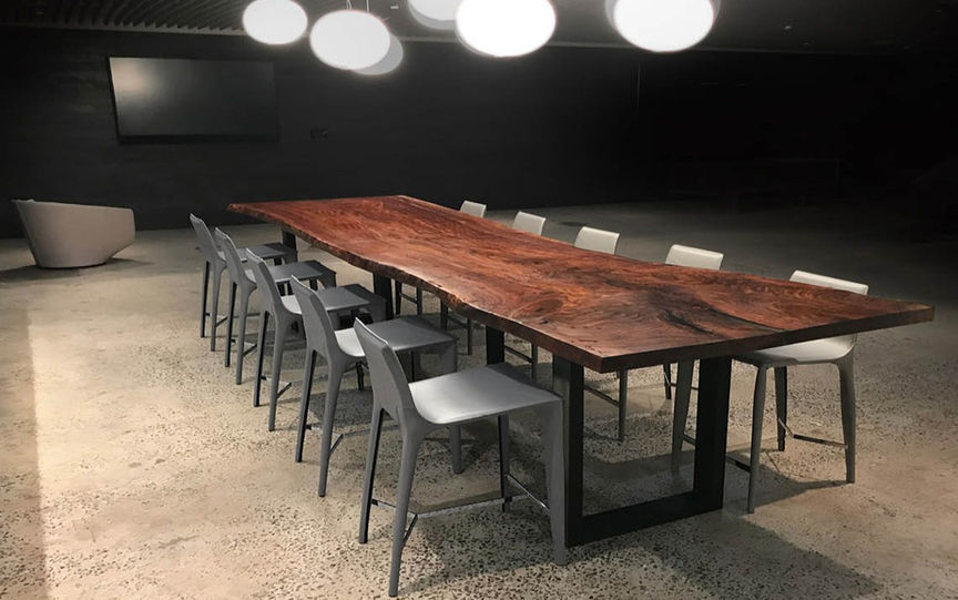 Made from a single 14' live edge Walnut slab. Cut in half for elevator clearance, and joined back together with the best fasteners on the market. The edges of this pieces were extremely rough and decayed. We salvaged it by sculpting the live edge back and filling the voids with a clear acrylic resin that blended in beautifully.