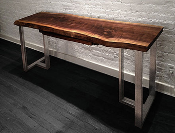 Live edge desk shown with industrial steel base with a live edge walnut wood slab, natural tree slice desk top..