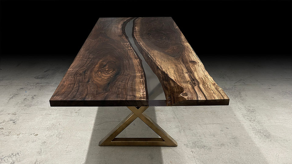 Live edge river table shown with epoxy river on an walnut bookmatched slab set.