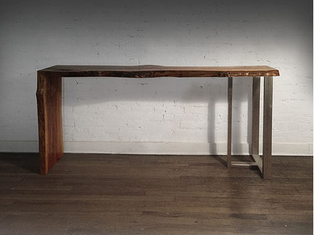 Live edge console table shown with wooden waterfall leg and steel Tribeca leg with a live edge cherry wood slab, natural tree slice.
