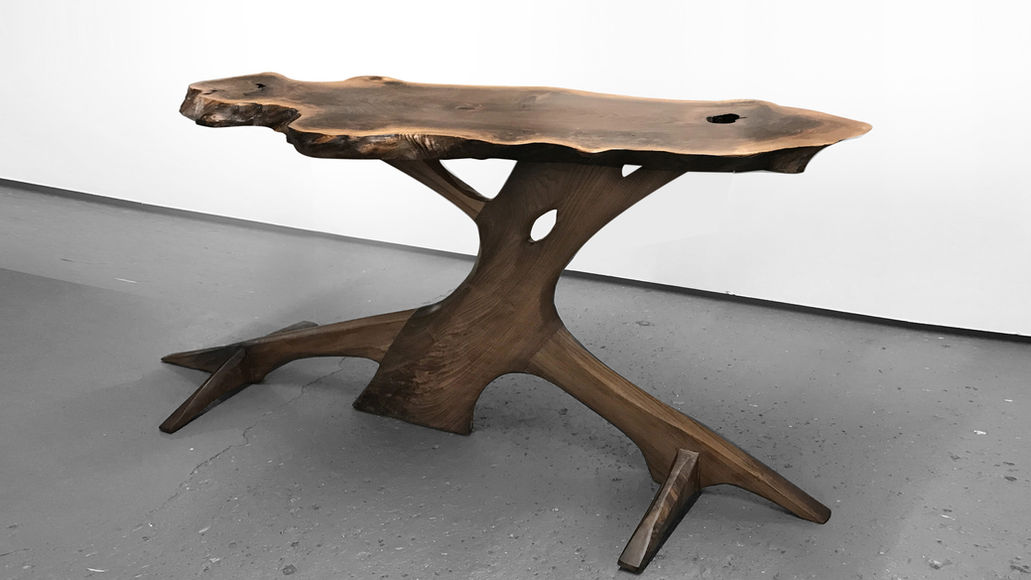 Live edge root base table made from sculpted walnut. Natural organic shaped tree furniture.