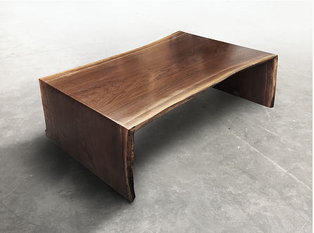 Live edge coffee table shown with wooden waterfall legs with a live edge walnut wood slab, natural tree slice.