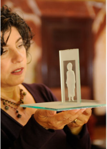 Janna Waldinger holding "On The Threshold" Sand Blasted Glass Sculpture; Photo Credit: Lowell Downey