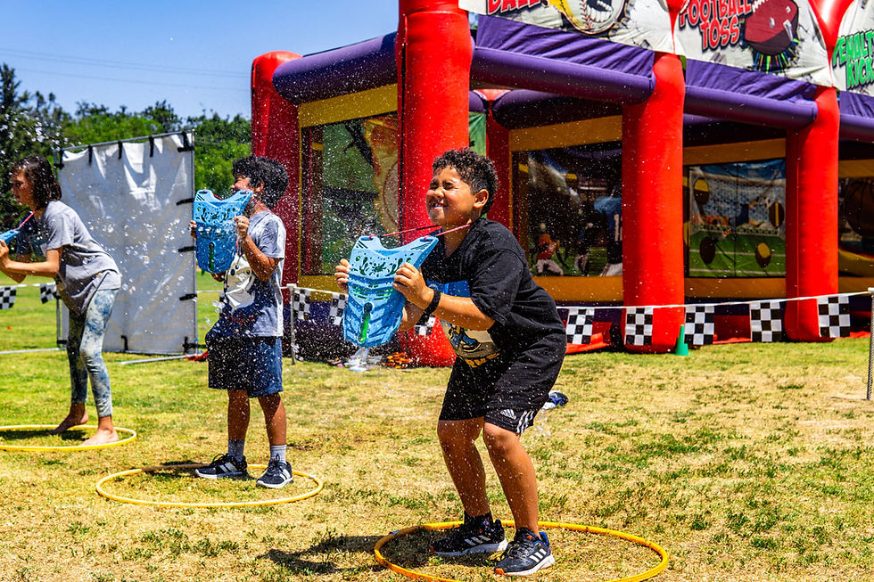 Kids participating in outdoor water games at a Toronto festival, perfect for catered public events and school fun days