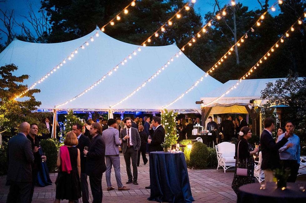 Corporate outdoor event in Toronto with elegant tent and string lighting setup