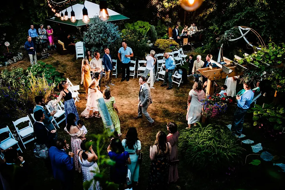 Lively backyard wedding with guests enjoying music, dancing, and outdoor festivities