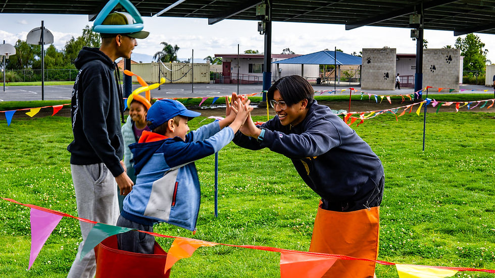 Kids enjoying sack races at a school field day event in Toronto, ideal for catered school fundraisers and outdoor activities