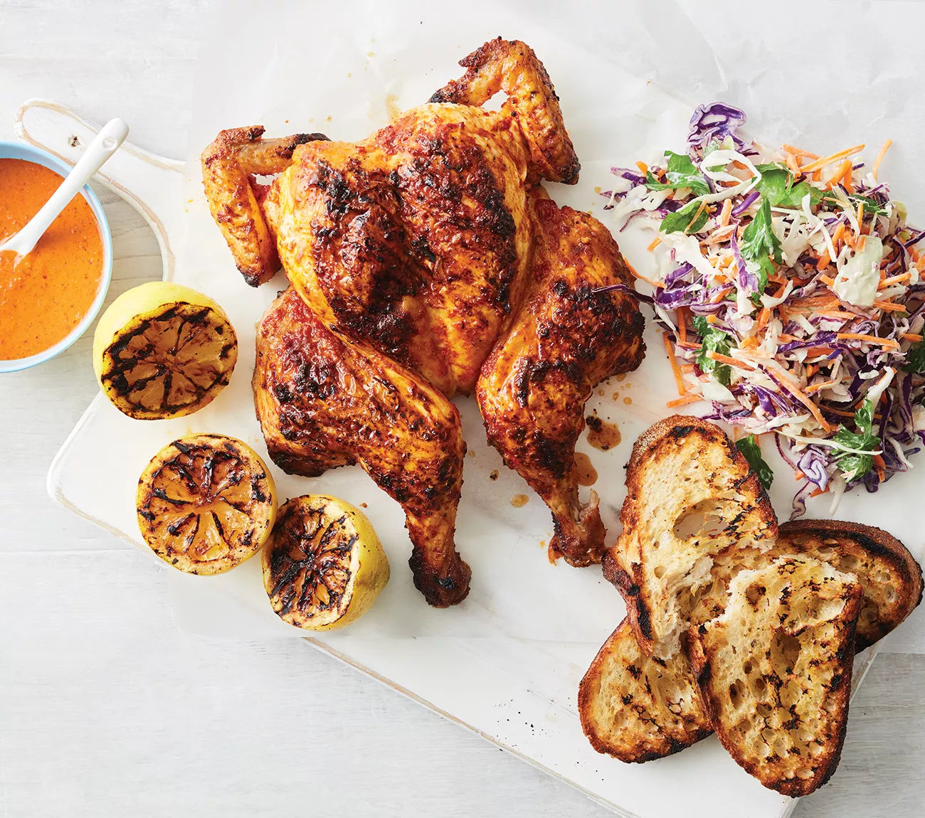 BBQ chicken platter paired with grilled lemons, artisan bread, and coleslaw, served by Always Fresh BBQ Catering for weddings, birthdays, and corporate catering.