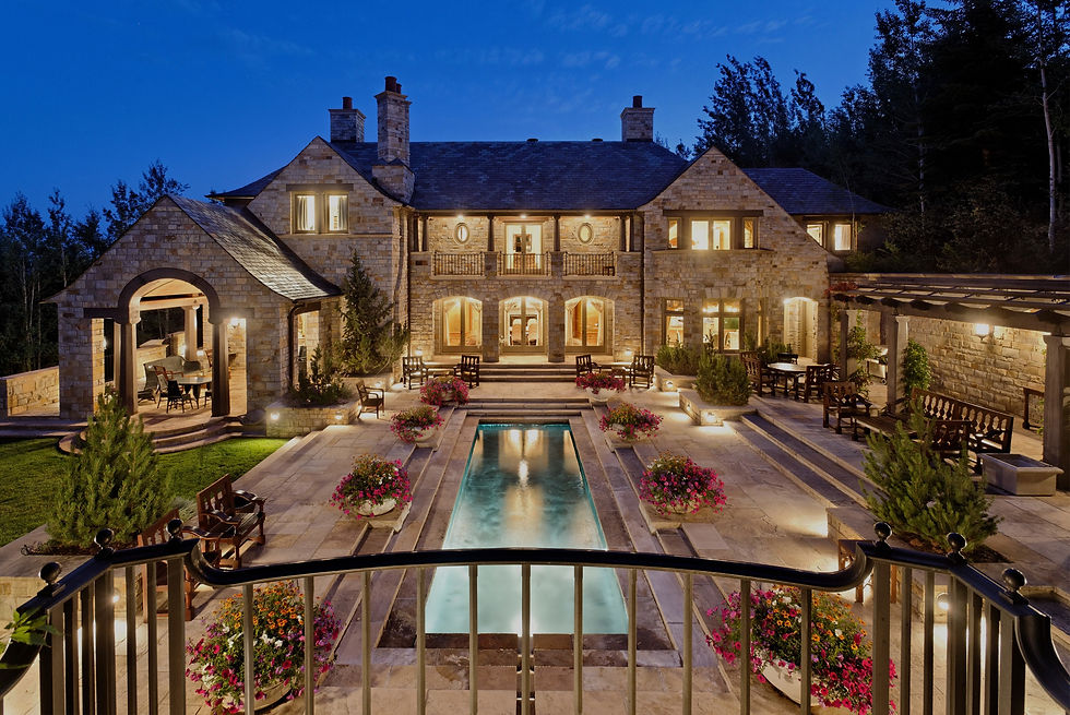 Elegant mansion at night with pool and landscaping