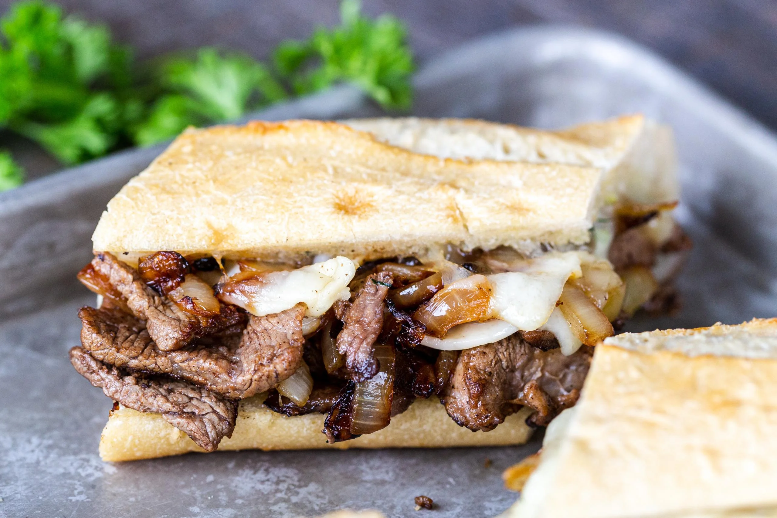Grilled beef Philly cheesesteak topped with melted cheese by Always Fresh BBQ Catering, perfect for corporate BBQ catering, birthday celebrations, and private parties.