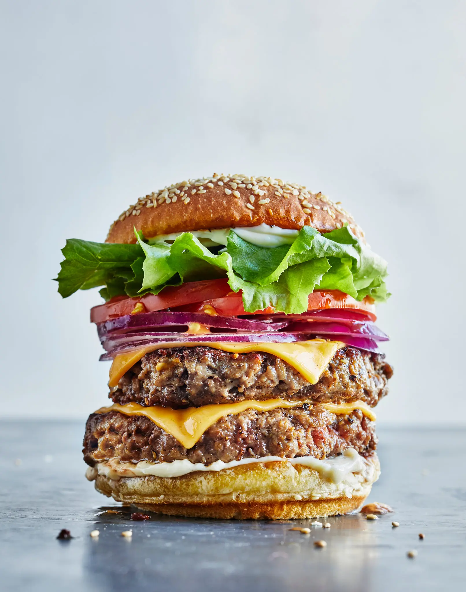 Towering triple cheeseburger with fresh toppings by Always Fresh BBQ Catering, great for backyard birthday parties, corporate BBQs, and exclusive private events.