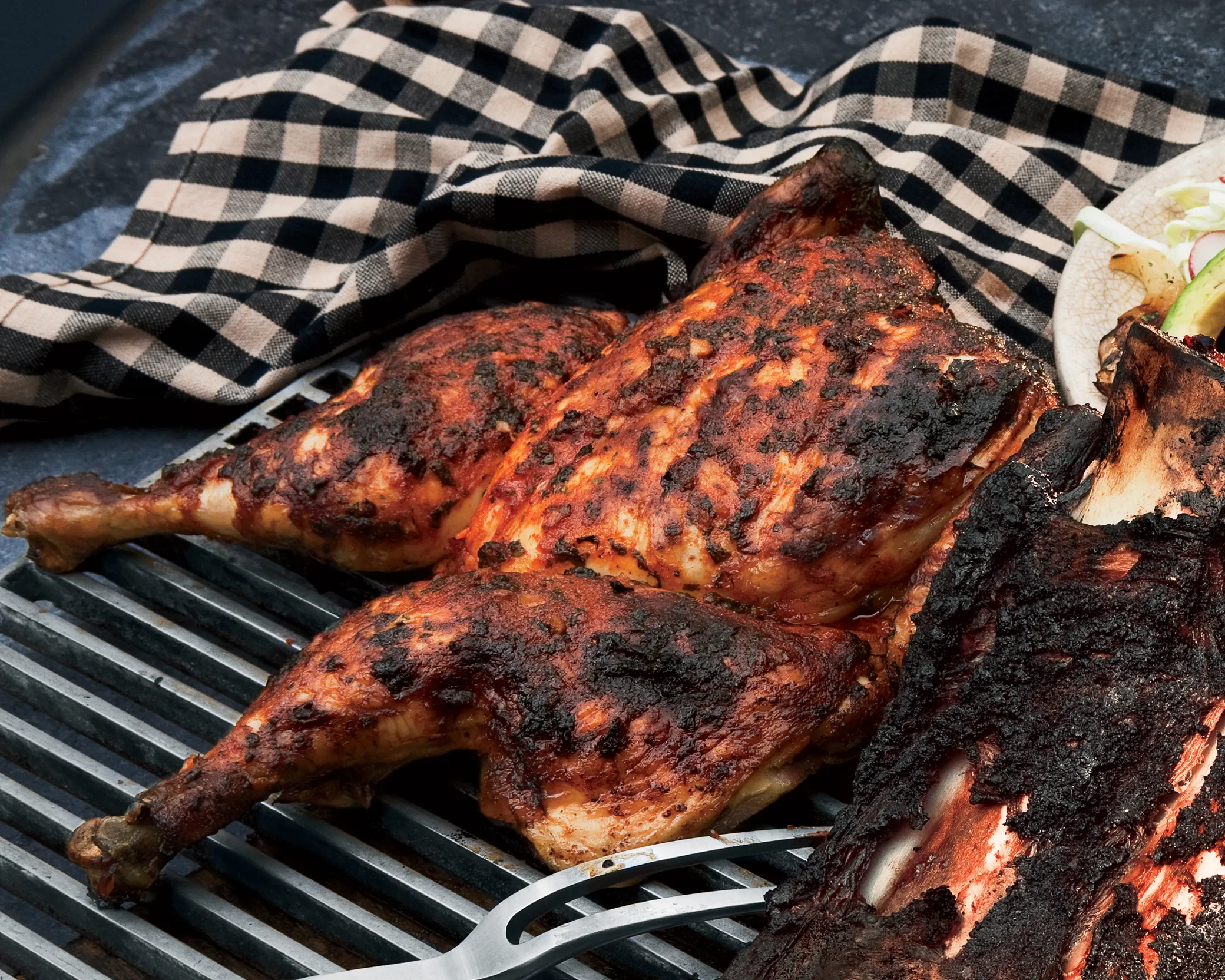 Whole BBQ chicken charred over fire, wrapped in checkered cloth by Always Fresh BBQ Catering, popular for outdoor birthday parties, private celebrations, and corporate BBQs.