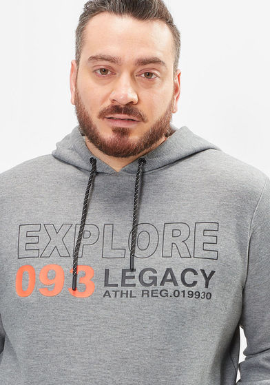 Hadi wearing a grey hoodie