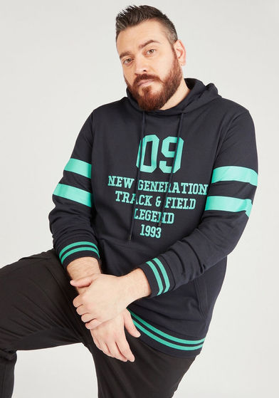 Hadi wearing a black hoodie with aqua stripes